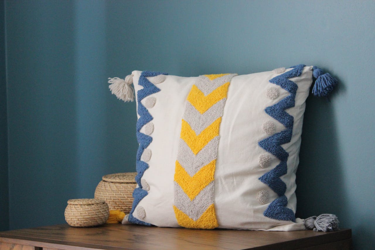 services-03 A modern throw pillow with chevron pattern and tassels, perfect for cozy interiors.